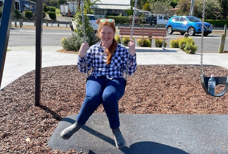 Jacoba on a swing at a playground