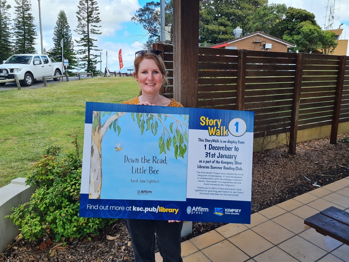 A lady holding a sign 