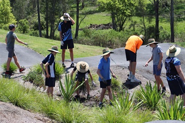 Students planting at the pump track