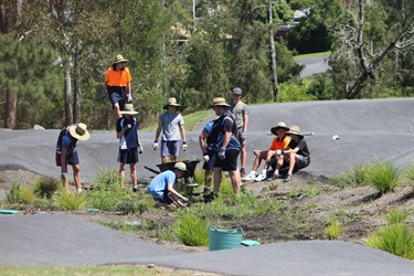 Students planting at the pump track