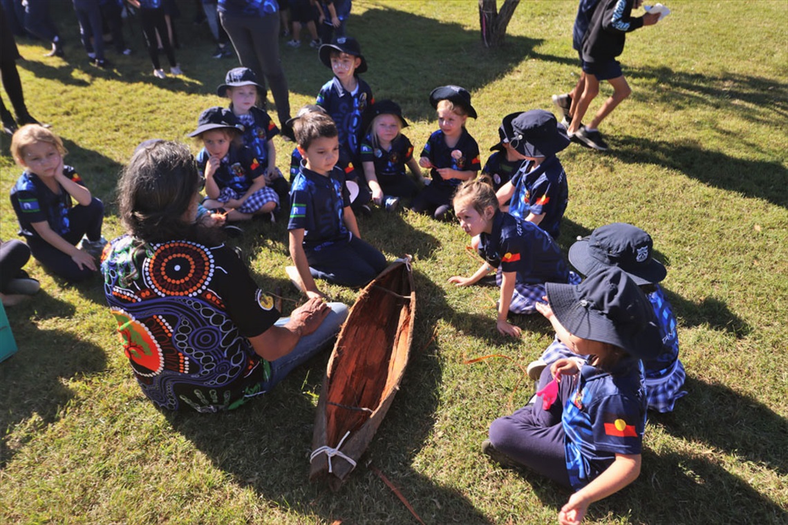 a group of students learning about local aboriginal culture