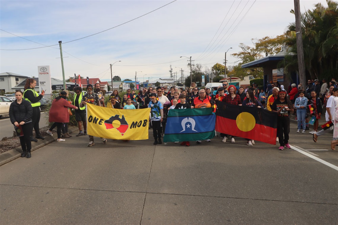 People marching down the street for NAIDOC Week