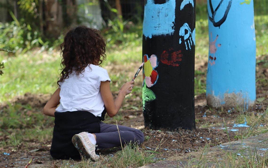 Community painting Deadly Totem Poles in Steele Park, North Street West Kempsey