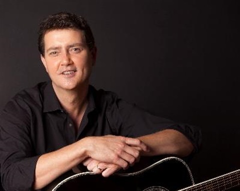 Adam Harvey with guitar 