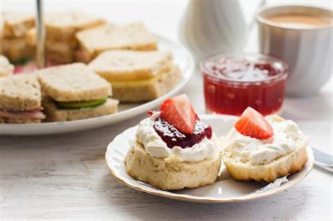 sandwiches and scones on plates
