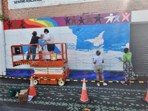 artists painting wall mural