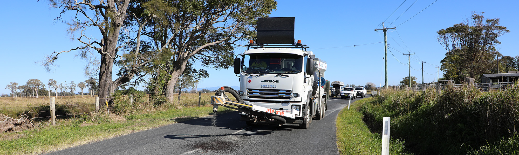 a jet patcher repair pot holes on a local road