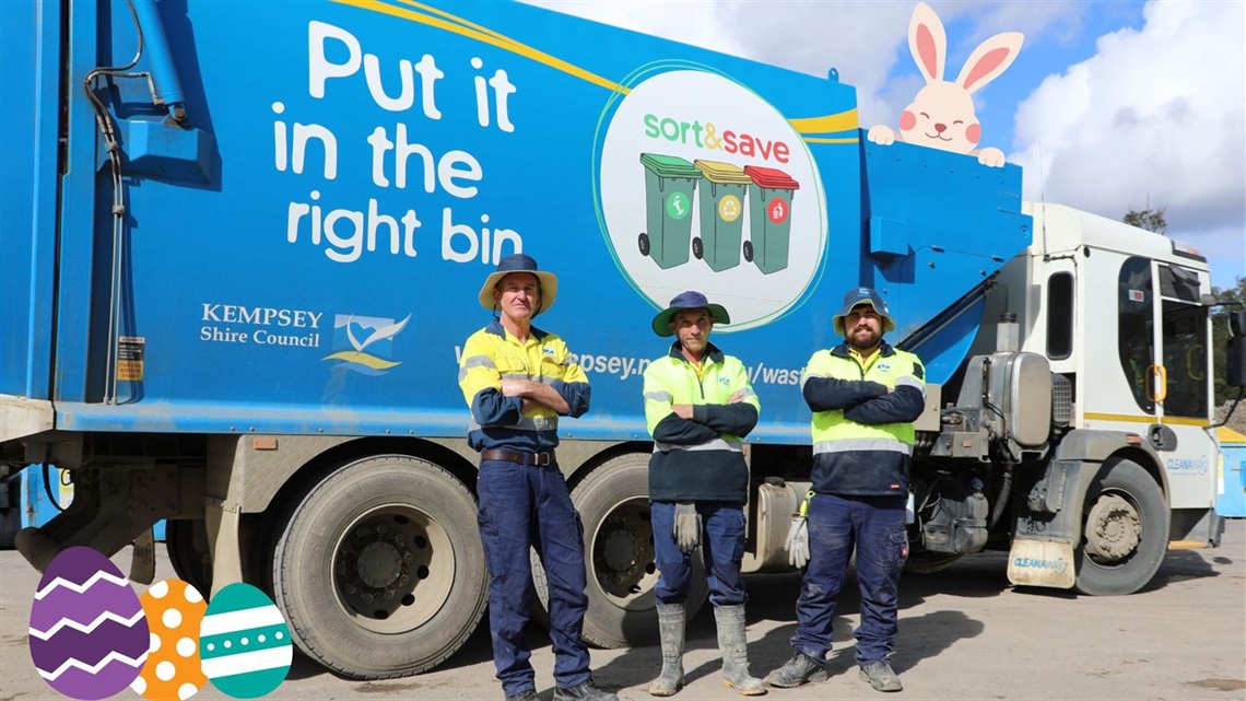 men standing in front of a waste collection truck