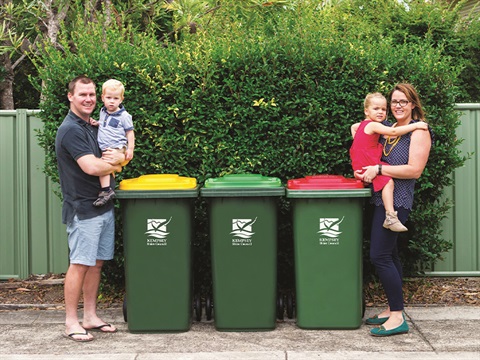 Three waste bins with family