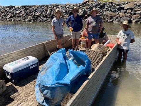 people in boat with rubbish