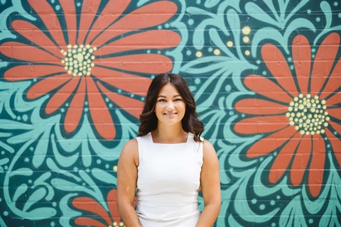 Mayor standing in front of mural
